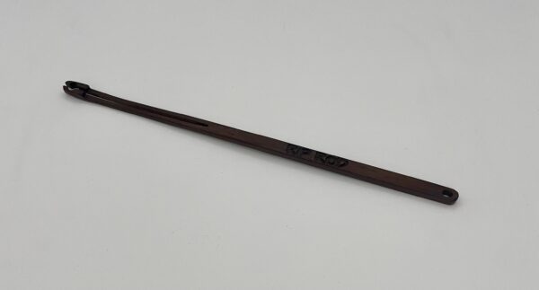 A long, thin, dark brown "Tropical Walnut" wooden shoehorn with a slot at one end and "RE-ROD" engraved on the handle, placed on a plain white background.