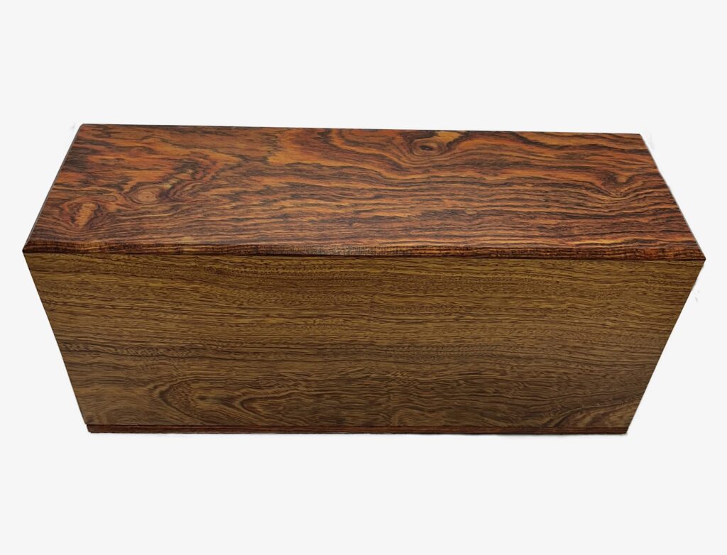 A rectangular wooden box with a smooth finish and distinct, swirling grain patterns in shades of brown and reddish tones.