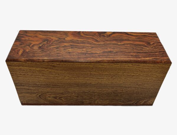 A rectangular wooden box with a smooth finish and distinct, swirling grain patterns in shades of brown and reddish tones.