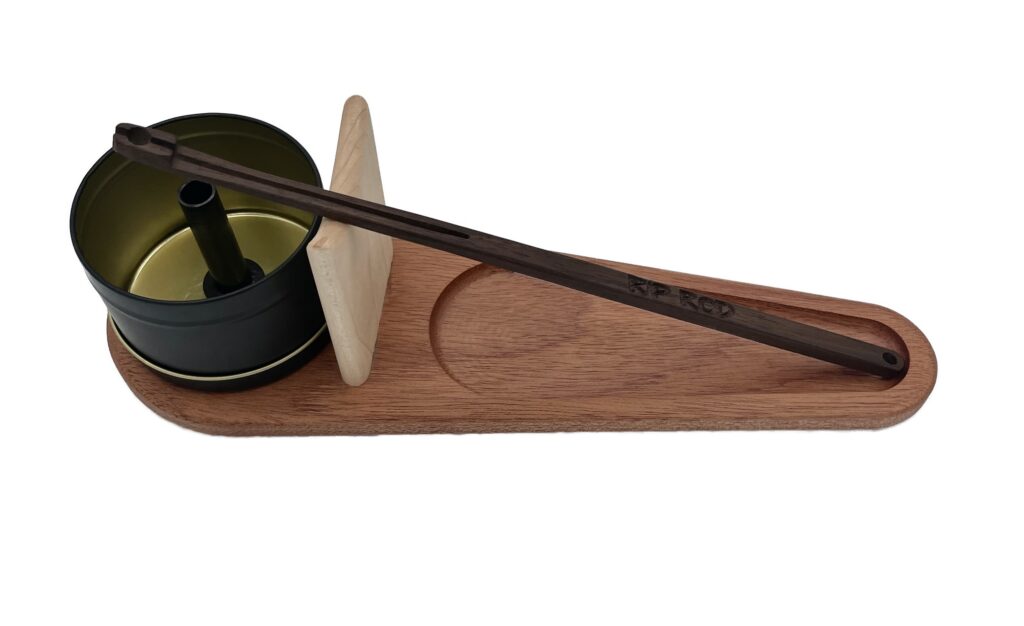 The Rip Rod Essentials set features a wooden tray with a metal cup, round wooden lid, and long dark wooden chopsticks, all neatly arranged on a white background.