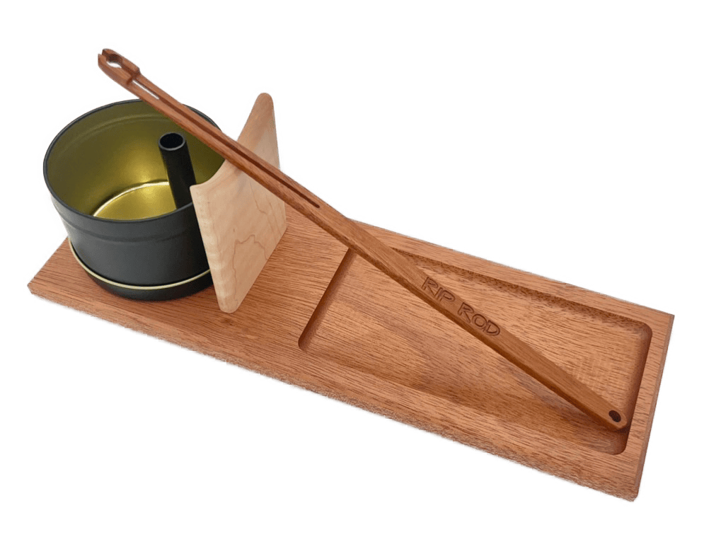 The Rip Rod Essentials includes a wooden rolling tray with compartments, a metal canister, a wooden scraper, and a long wooden tool labeled "RIP ROD" resting on top.